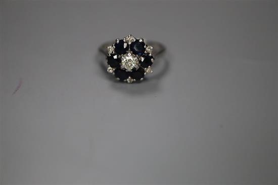 An 18ct, sapphire and diamond set cluster ring, size K, gross 4 grams.